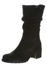 Bottine noire décontractée en cuir texturé, dotée d'un talon bloc épais, d'un bout arrondi et de détails de coutures minimalistes sur les côtés.