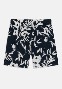 Marineblå shorts med et hvitt blomstermønster. Laget av stoff med en glatt tekstur, inkluderer elastisk midjebånd og baklomme.