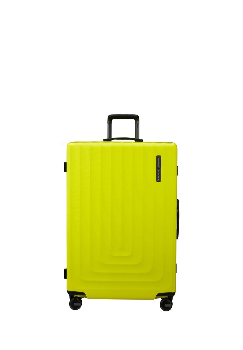 Hard-shell suitcase in bright yellow plastic, featuring a textured wave pattern, a retractable black handle, and four black wheels.