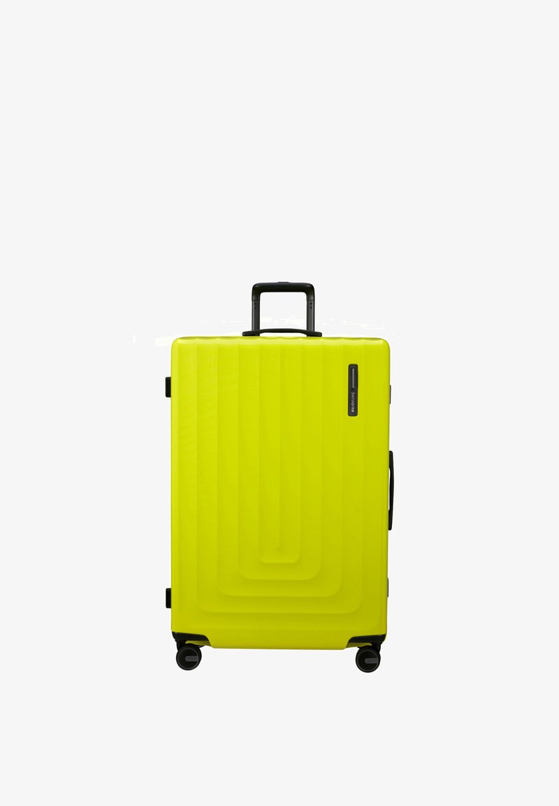 Hard-shell suitcase in bright yellow plastic, featuring a textured wave pattern, a retractable black handle, and four black wheels.