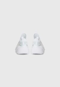 White athletic shoes with a sleek design, mesh upper, and pull tabs at the heel. The sole is textured for traction and support.