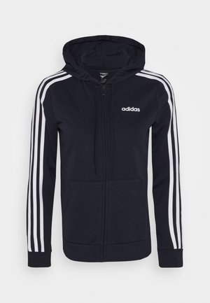 Marineblå Adidas hættetrøje med lynlås med hvide tre striber på ærmerne, forlommer, snøretræks-hoodie og Adidas-logo på brystet.