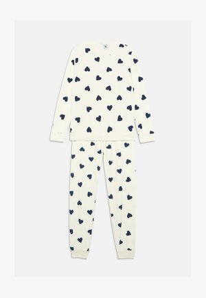 Zwei-teiliges Baumwoll-Pyjama-Set mit einer cremefarbenen Basis und navyblauem Herzdruck. Lange Ärmel und elastischer Bund an der Hose. Weicher Stoff.