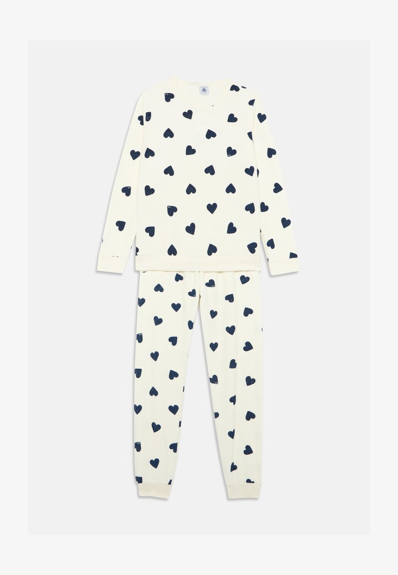 Zwei-teiliges Baumwoll-Pyjama-Set mit einer cremefarbenen Basis und navyblauem Herzdruck. Lange Ärmel und elastischer Bund an der Hose. Weicher Stoff.