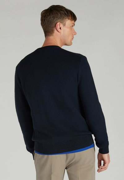 Navy blue knitted sweater with a round neck, ribbed hem, and long sleeves. Smooth texture with a solid color, no visible patterns or accents.