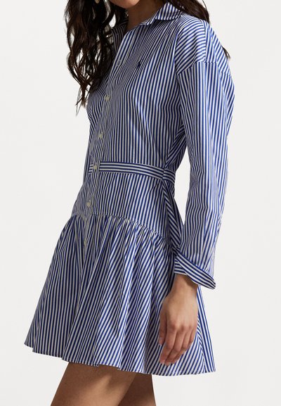Blue and white striped button-up dress with long sleeves, a fitted waist, and a flared skirt. Features a collar and visible buttons.