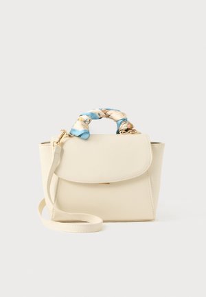 Cream handbag with flap closure, detachable shoulder strap, and twisted blue and cream floral fabric wrapped around the top handle.