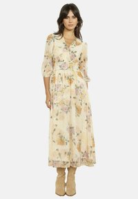 Pikk lilleline kleit läbipaistvast kreemjast kangast, millel on V-kaelus, kolmveerand varrukad ja roosades ja kollastes toonides värvikirevad lillemustrid.