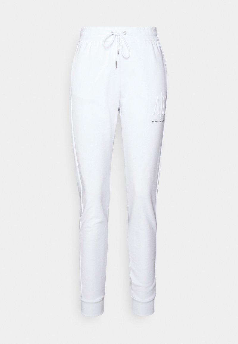 Vita mjukisbyxor i en mjuk bomullsblandning, med dragsko i midjan, smalnande ben och en logotyp på vänster lår.