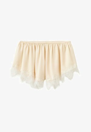 Crèmekleurige off-shoulder blouse met elastische halslijn en delicate kanten rand langs de getande zoom.