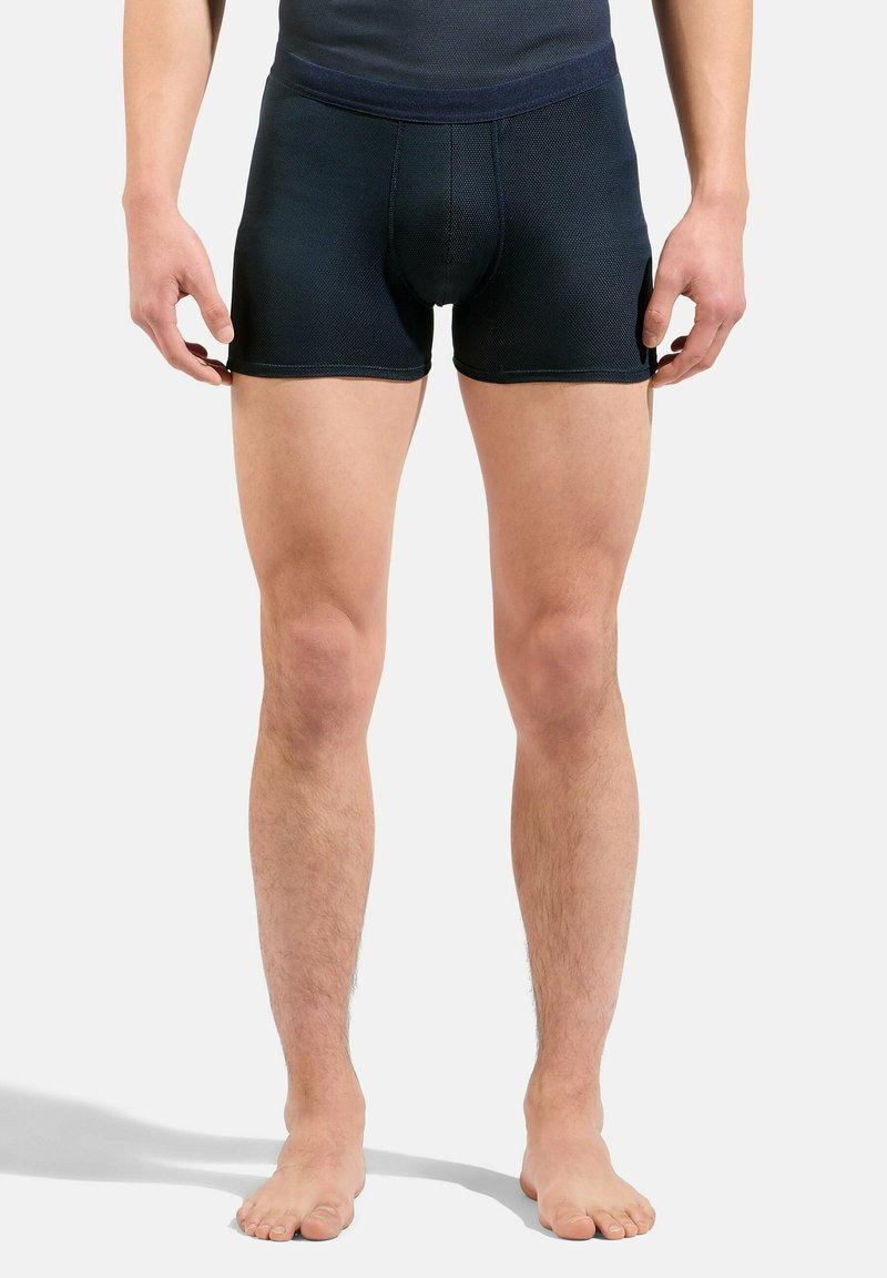Un caleçon en bleu marine foncé, en tissu texturé, présentant un design ajusté et une taille lisse, sans motifs ni éléments visibles.