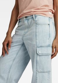 Lichtblauwe cargobroeken met een relaxte pasvorm, voorzien van zijzakken, een knoopsluiting en een licht vervaagde, gestructureerde denim stof.