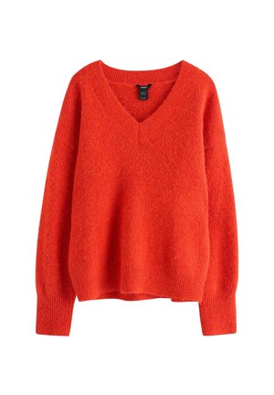 Maglione oversize a scollo a V in arancione vivace. Realizzato in morbido tessuto lavorato a maglia con texture. Maniche lunghe con polsini e orlo a coste.