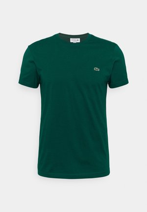T-shirt Lacoste manches courtes vert foncé avec col rond et petit logo crocodile sur le côté gauche de la poitrine.
