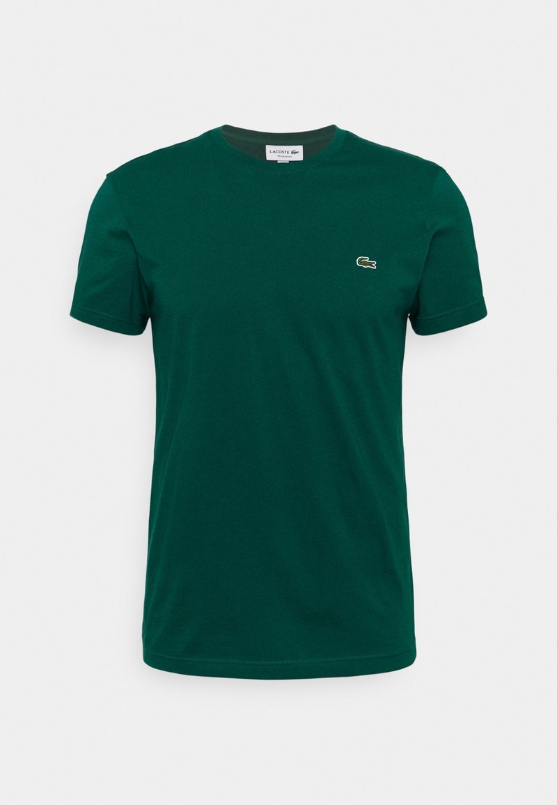 T-shirt Lacoste manches courtes vert foncé avec col rond et petit logo crocodile sur le côté gauche de la poitrine.