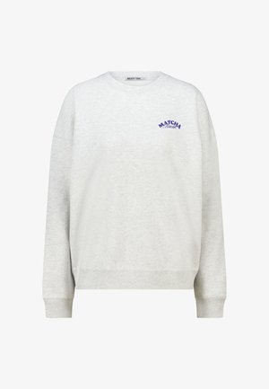Grey sweatshirt made of a soft material featuring dropped shoulders, long sleeves, and purple "MATCHA Beach" graphic detail on the chest.