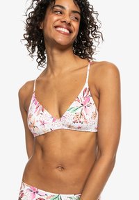 Bloemenbikini-top met driehoekige cups, met een witte basis en kleurrijke roze en groene bloemenpatronen. Verstelbare dunne bandjes.