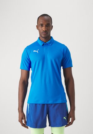 Blue polo shirt made of breathable fabric with a collar, featuring a white logo on the left chest, paired with navy shorts and neon accents.
