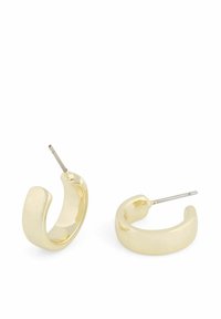 Guld, tjocka hoopörhängen med en slät, polerad yta och en tunn metalldorn för säker fästning, som visar en modern, minimalistisk design.