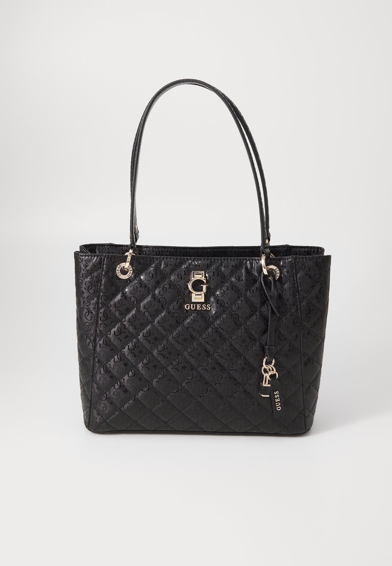 Borsa tote nera trapuntata con motivo in rilievo, accessori in oro e doppi manici. Dotata di una placca con logo e un ciondolo rimovibile.
