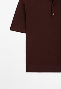 Brun kortärmad polo skjorta i slätt tyg, med en tvåknappslå och ribbade muddar samt rak fåll.