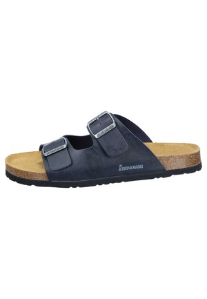 Black slide sandal with two adjustable metal buckles, cork footbed, and black sole, labeled with the brand Brinkmann.
