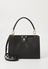 Black leather handbag with a textured finish, gold hardware, a top handle, and a detachable shoulder strap. Features a closure with a logo plaque.