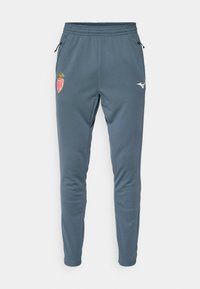 Pantalons de sport bleus avec taille élastique, poches zippées sur les côtés, emblème du club de football AS Monaco sur la cuisse gauche et logo Mizuno sur la cuisse droite.