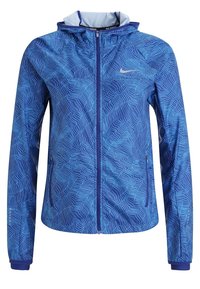 Veste légère bleue avec un motif de vagues, fermeture éclair à l'avant et capuche. Fabriquée en tissu lisse avec des poignets élastiques. Logo Nike sur la poitrine.