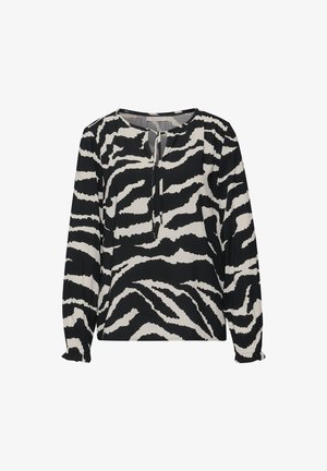 Bluzka z długim rękawem wykonana z lekkiego materiału, w czarno-białym wzór zebry, z okrągłym dekoltem i marszczonymi mankietami.