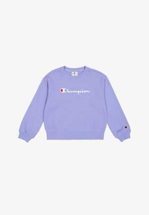 Sweat-shirt en polaire lavande avec col rond, poignets et ceinture côtelés. Présente un logo "Champion" en blanc audacieux et un petit logo sur la manche.