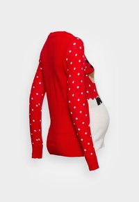Czerwony sweter ciążowy z długimi rękawami w białe kropki. Z przodu znajduje się wzór przedstawiający bałwana. Miękka dzianinowa struktura.