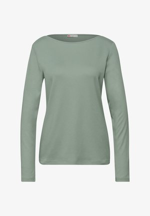 Tričko s dlouhým rukávem v jemné, tlumené zelené barvě z bavlny. Má široký výstřih a volný střih. Hladká textura s minimem švů.