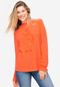 Oranje lange mouwen shirt met een losse pasvorm en een print van een wortelkarakter. Zachte textuur, ribbelachtige halslijn en recht afgesneden mouwen.