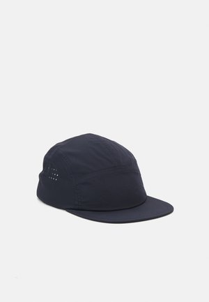 Navy fabric cap with a rounded crown, flat brim, and side ventilation holes. Made from lightweight material for breathability.
