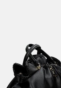 Borsa a mano in pelle nera con texture liscia, design arricciato, accenti intrecciati e doppio manico. La ferramenta include un piccolo tag con logo.