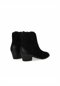 Bottines noires en cuir suédé et cuir lisse, avec un bout rond et un talon effilé. Fermeture éclair à l'arrière.