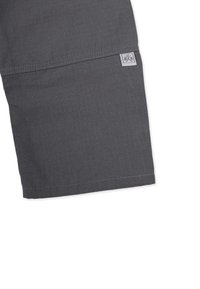Gray shorts made of lightweight fabric with a textured pattern. Features a hemmed edge and a small branded label stitched on the side.