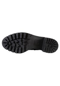 Black rubber boot sole with deep treads, featuring a zigzag pattern for traction and a rounded shape, marked with logo and size.