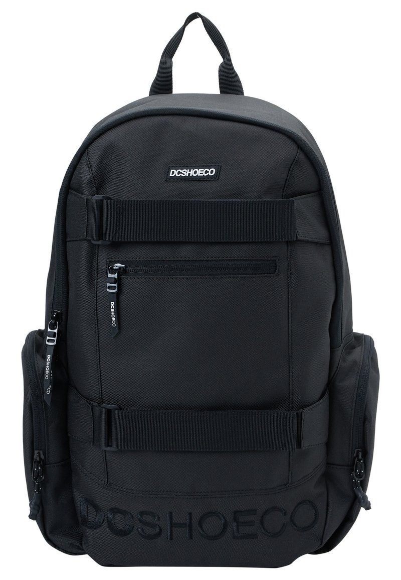 Black fabric backpack with zippered compartments, adjustable straps, side pockets, and embossed DC Shoe Co logo on the front.