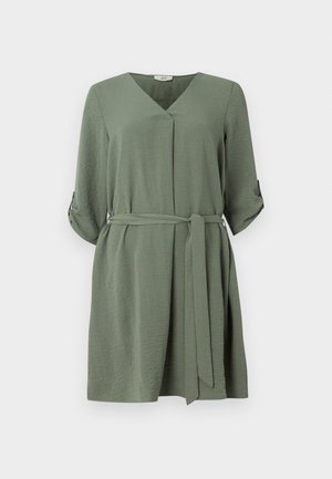 Light green wrap dress with a V-neck, three-quarter sleeves, and belt. Made of textured fabric, featuring rolled cuffs and a loose fit.