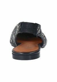 Black open-back sandal featuring a textured leather upper with circular cutouts, a smooth brown insole, and a low black sole.