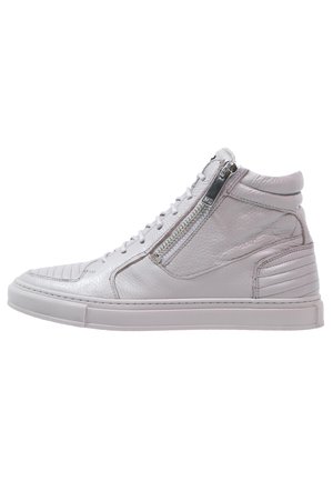White high-top sneaker with side zipper, lace-up front, padded collar, textured leather, and rubber sole.