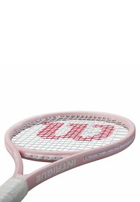 Tennis racket in pink with a white grip and red logo. Features a rounded head, open string pattern, and sleek curved shaft design.
