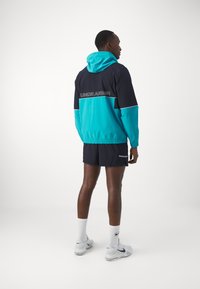 Under Armour ZONE WOVEN - Veste de survêtement - circuit teal/black/white