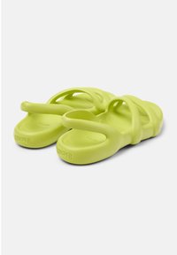 Green rubber sandals with multiple curved straps and a smooth texture, featuring subtle branding on the heel. Lightweight and flexible design.