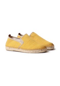 Scarpe slip-on gialle in tela con accenti beige e bordatura in juta intrecciata. Presentano una punta piatta e arrotondata e pannelli laterali elastici per una facile calzata.