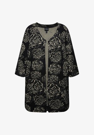 Black cardigan with cream rose pattern, open front, short sleeves, and a textured fabric; relaxed fit with a rounded hem.