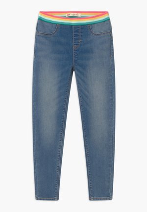 Jeans ajustados en denim azul medio, con una colorida cinturilla elástica acanalada con franjas rosas, verdes y amarillas. Cuatro bolsillos.