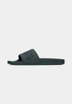 Black rubber slide sandal with a wide strap featuring a subtle embossed logo. Flat sole with a textured footbed for grip.